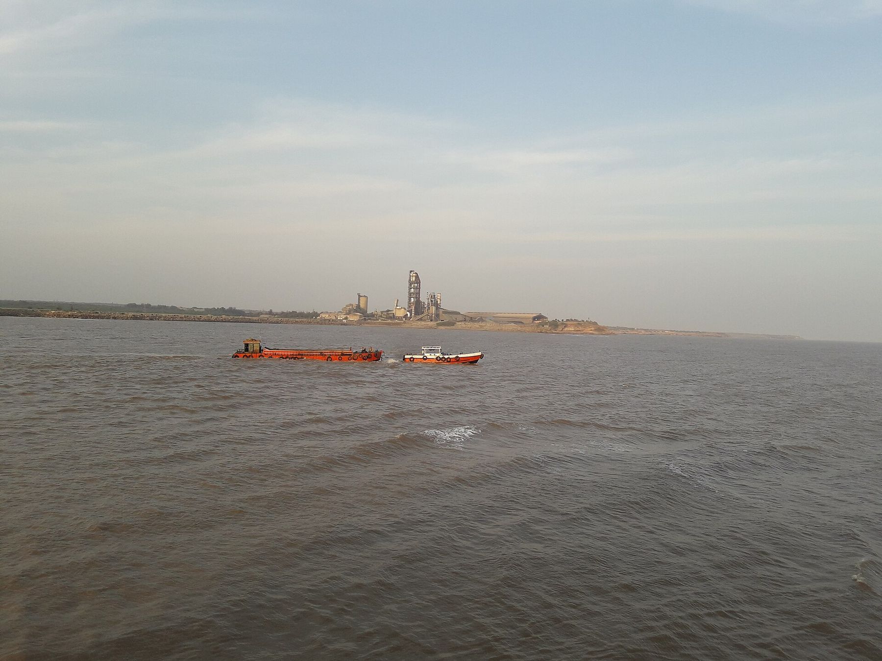 A cement works on the shore at Jafrabad, from the sea